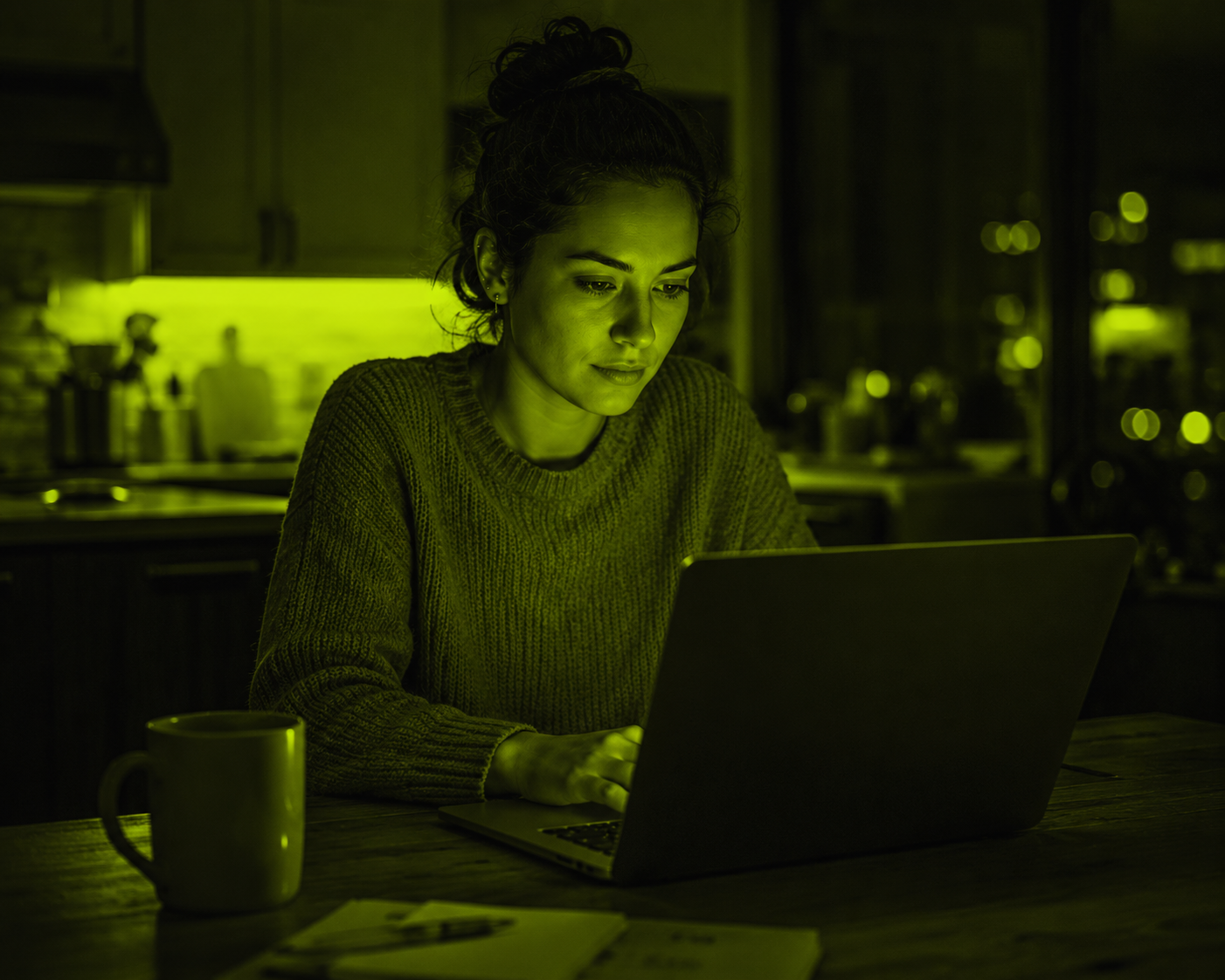 A side-hustler on a laptop at the kitchen table